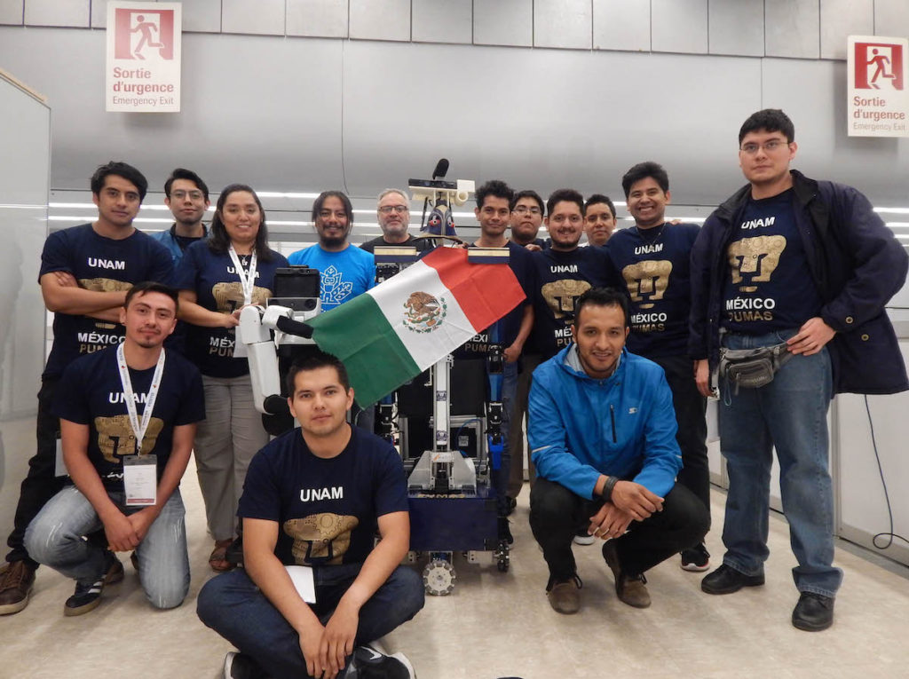 Equipo de la UNAM con uno de los robots ganadores