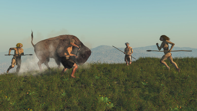 Hombres del neolítico cazando un bisonte- Fotolia